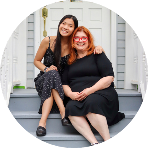 Young woman and mother smiling on staircase