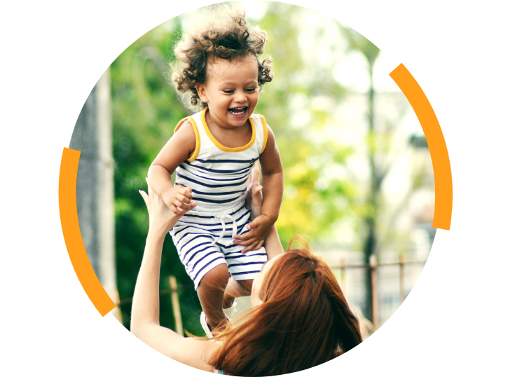 Young boy being tossed in the air laughing